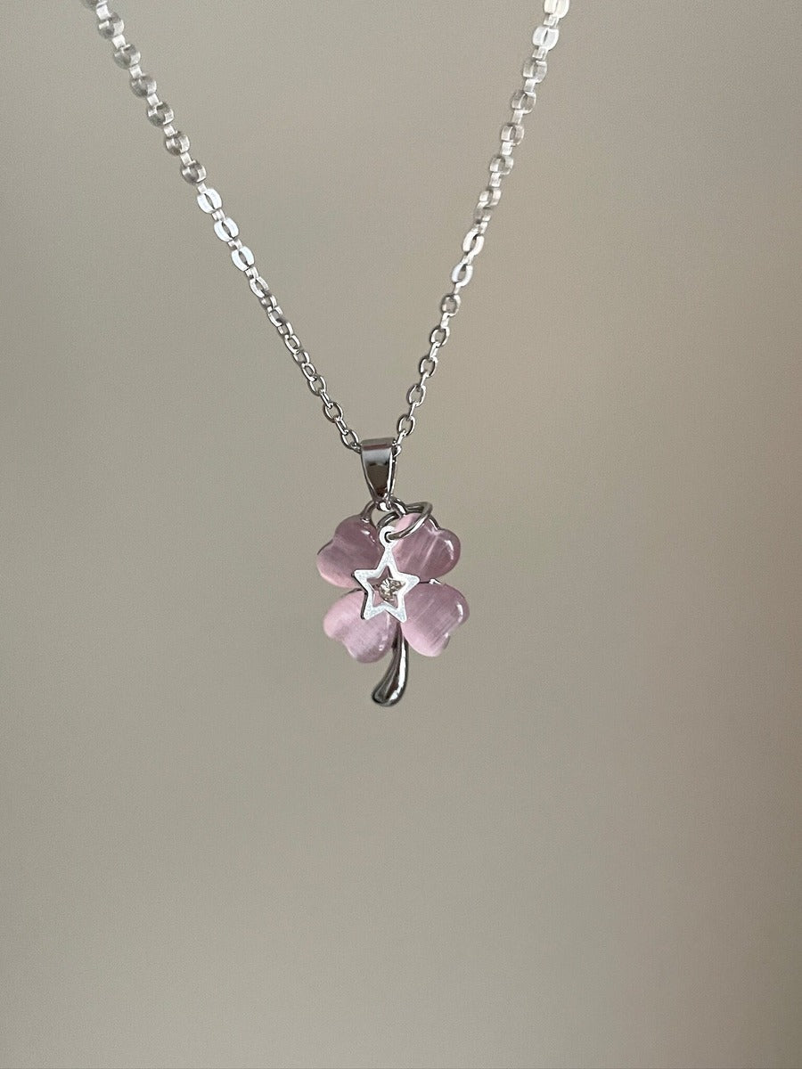 Necklace with a pink flower pendant on a plain background