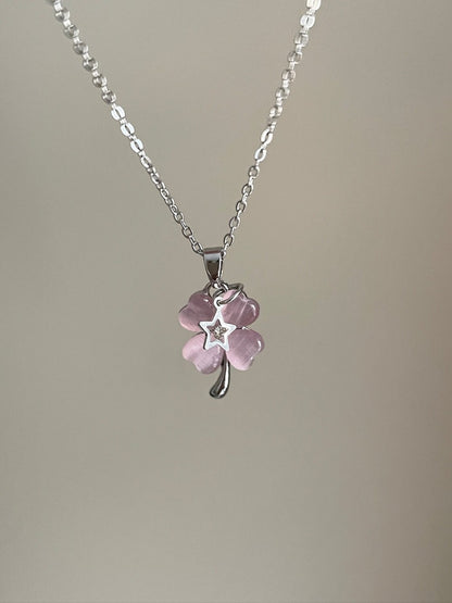 Necklace with a pink flower pendant on a plain background