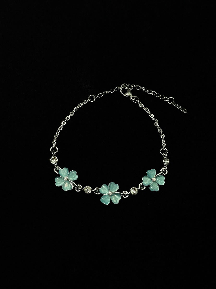 Bracelet with turquoise flower charms on a black background