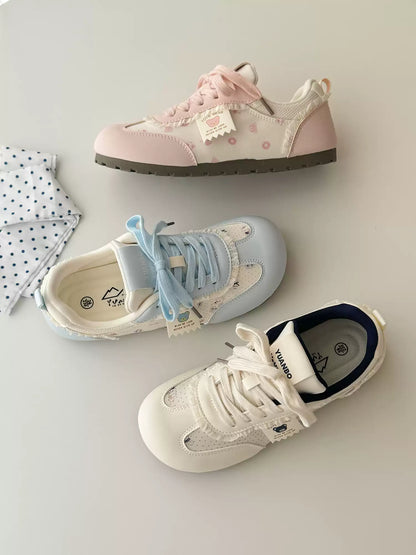 Three pairs of sneakers on a light gray surface with a white cloth.