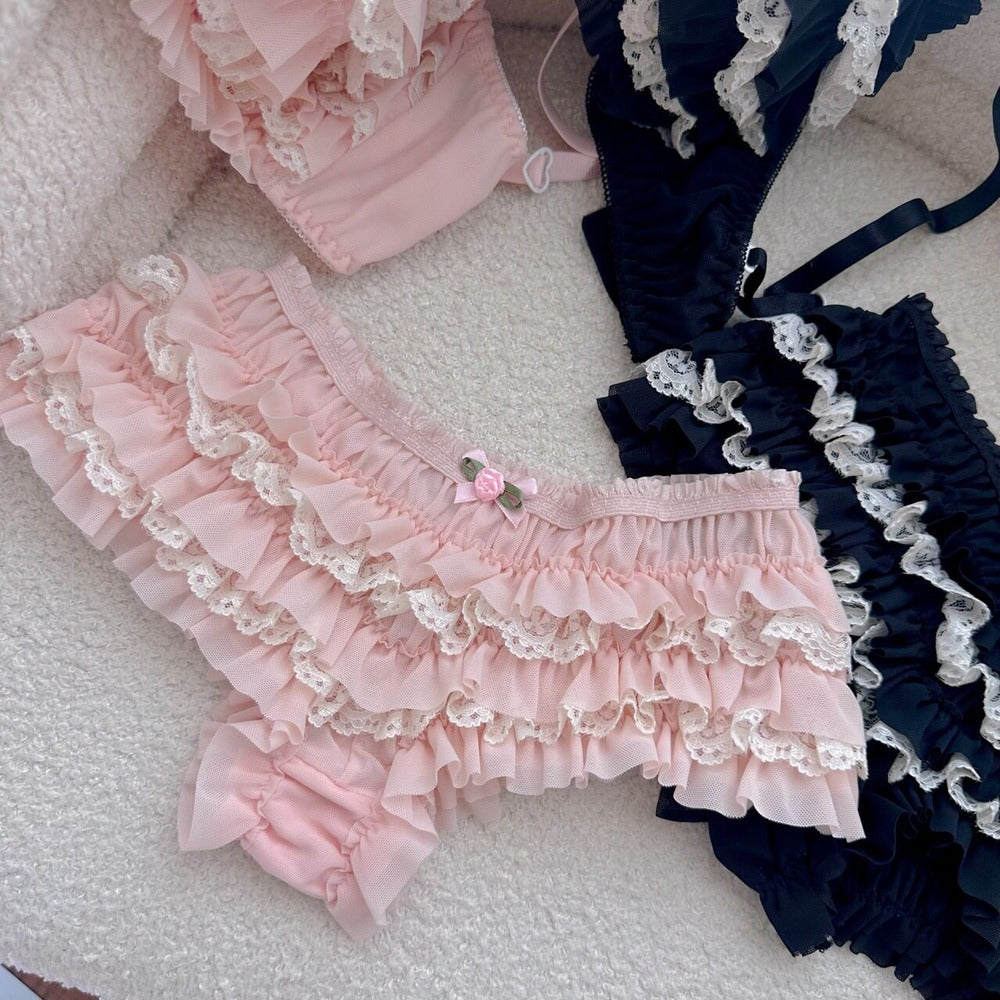 Pink and black ruffled bloomers on a textured surface