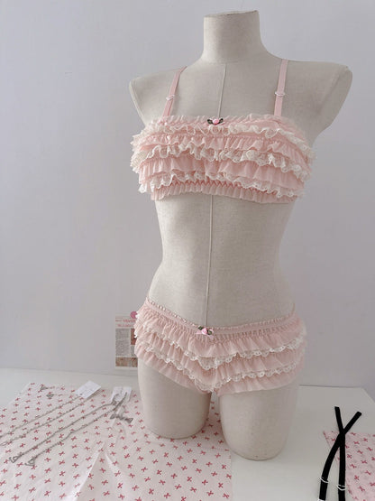 Pink ruffled lingerie set on a mannequin against a white background