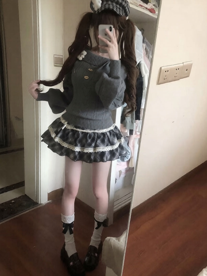 Person wearing a dark sweater and skirt with white lace trim, standing in front of a mirror.