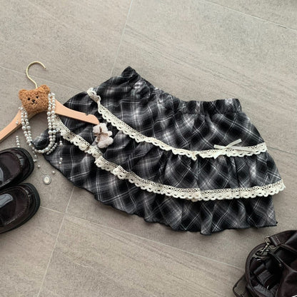 Plaid skirt with lace trim on a gray floor