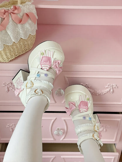 White shoes with cute cupcake pink bows on a pink dresser