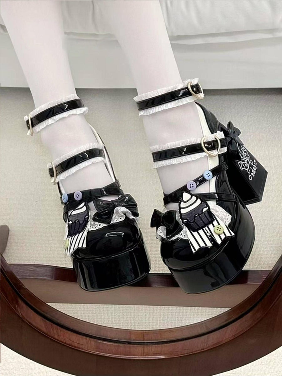 Black and white shoes with decorative elements on a neutral background