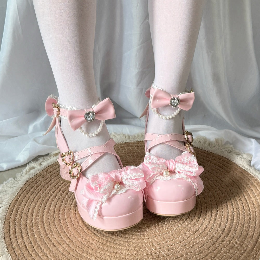 Pink bow shoes with decorative elements on a white fabric background