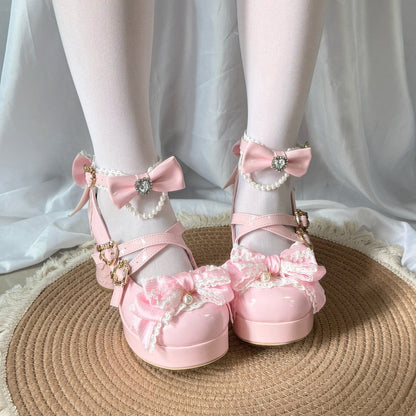 Pink bow shoes with decorative elements on a white fabric background