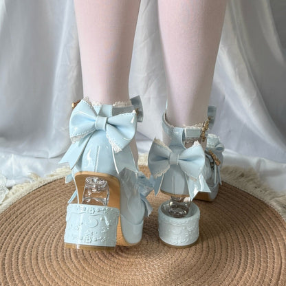 Light blue shoes with large bows worn by a person on a white background