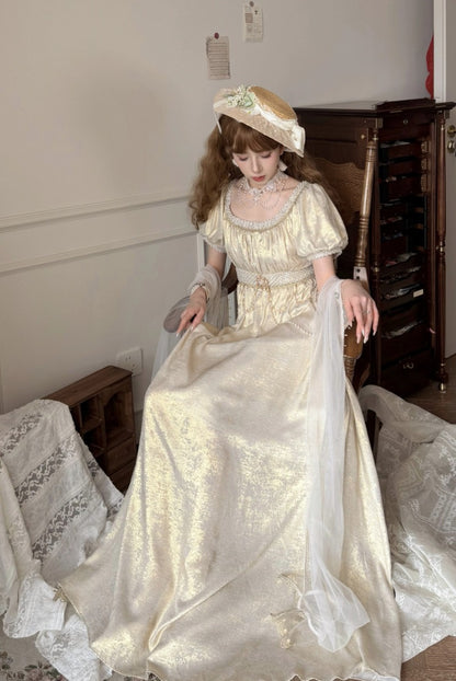 Woman in a vintage-style dress sitting on a chair in a room with wooden furniture.