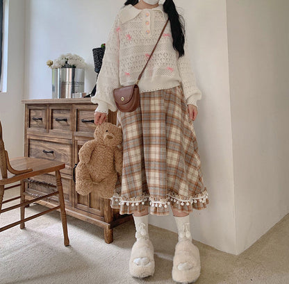Person wearing a plaid skirt and white sweater in a room with wooden furniture and decor.