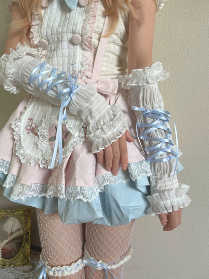 Person wearing a detailed pastel outfit with ruffles and ribbons against a neutral background