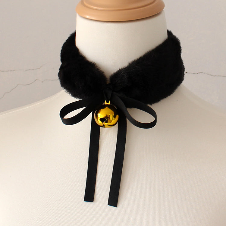 Black fur collar with a gold bell on a mannequin against a neutral background