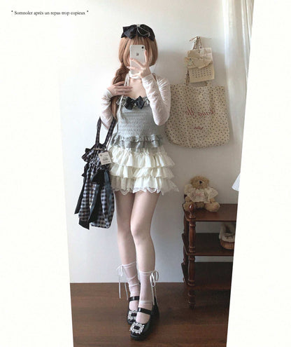 Person taking a mirror selfie wearing a layered outfit with a teddy bear and bag in the background.
