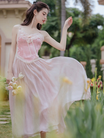 Woman in a pink dress standing in a garden with blurred background