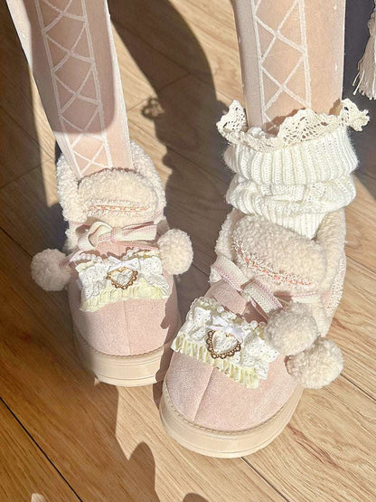Pink boots with white pom-poms and decorative elements on a wooden floor.
