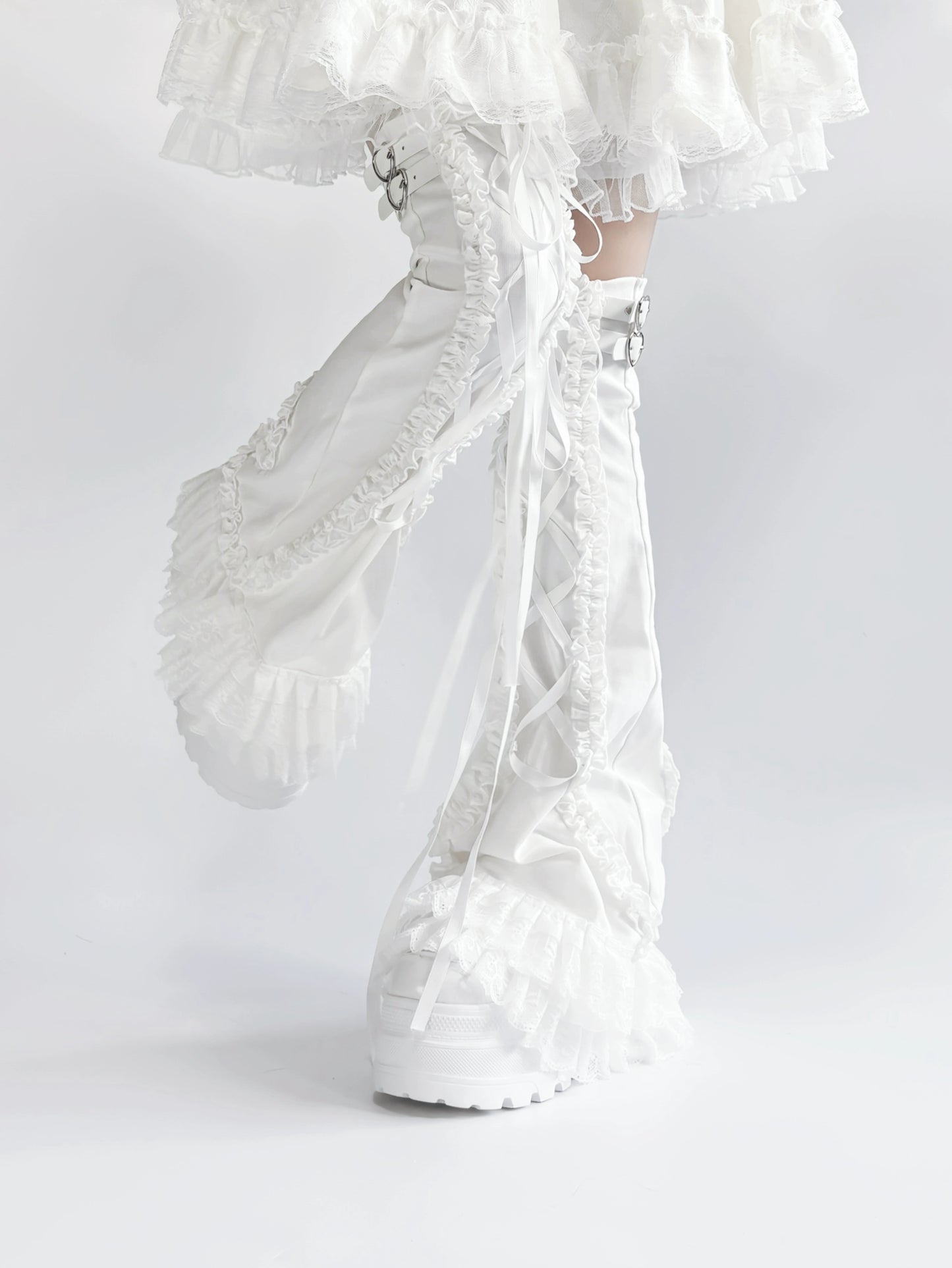 White lace leg warmers with ruffled details on a white background