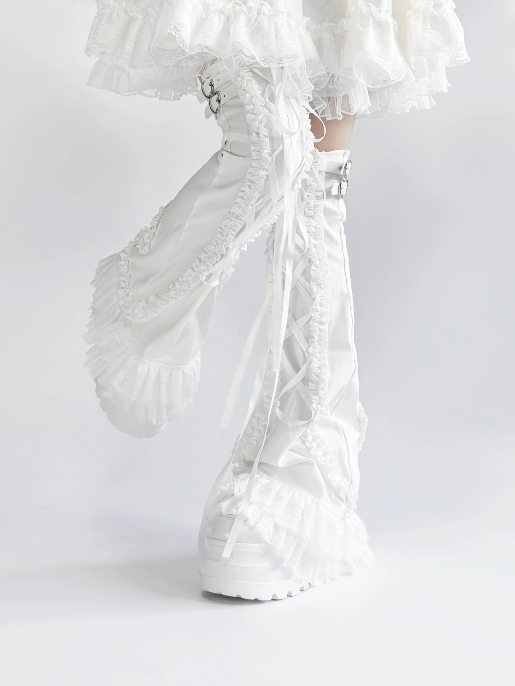 White lace leg warmers with ruffled details on a white background