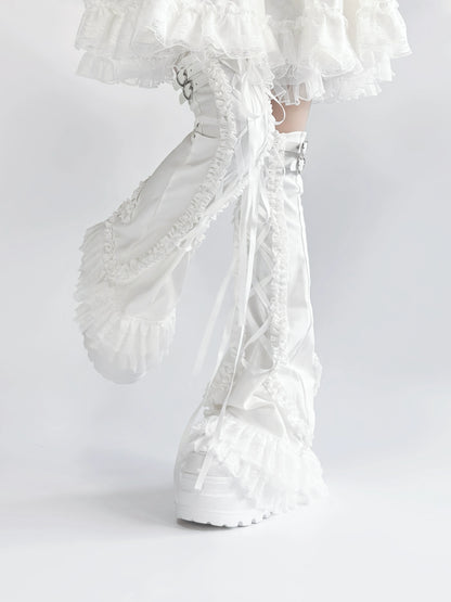 White lace leg warmers with ruffled details on a white background