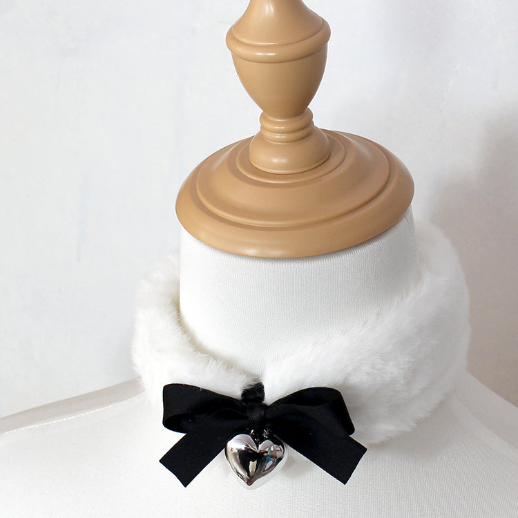 White fur collar with a black ribbon and silver heart charm on a white background