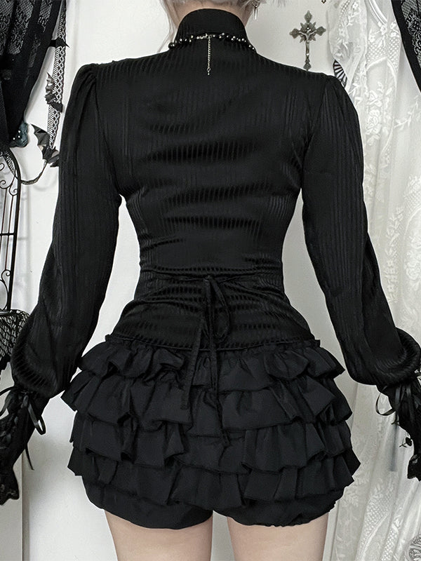 Black Victorian-style dress with ruffled skirt and long sleeves on a white background