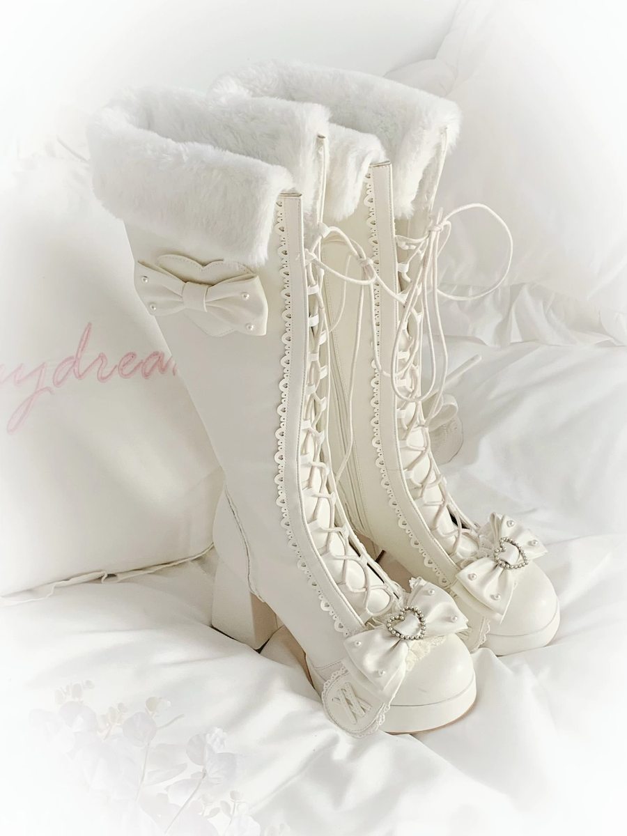 White lace-up boots with decorative elements on a white background