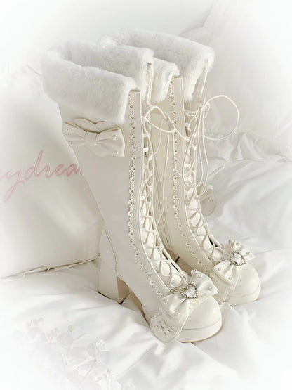 White lace-up boots with decorative elements on a white background