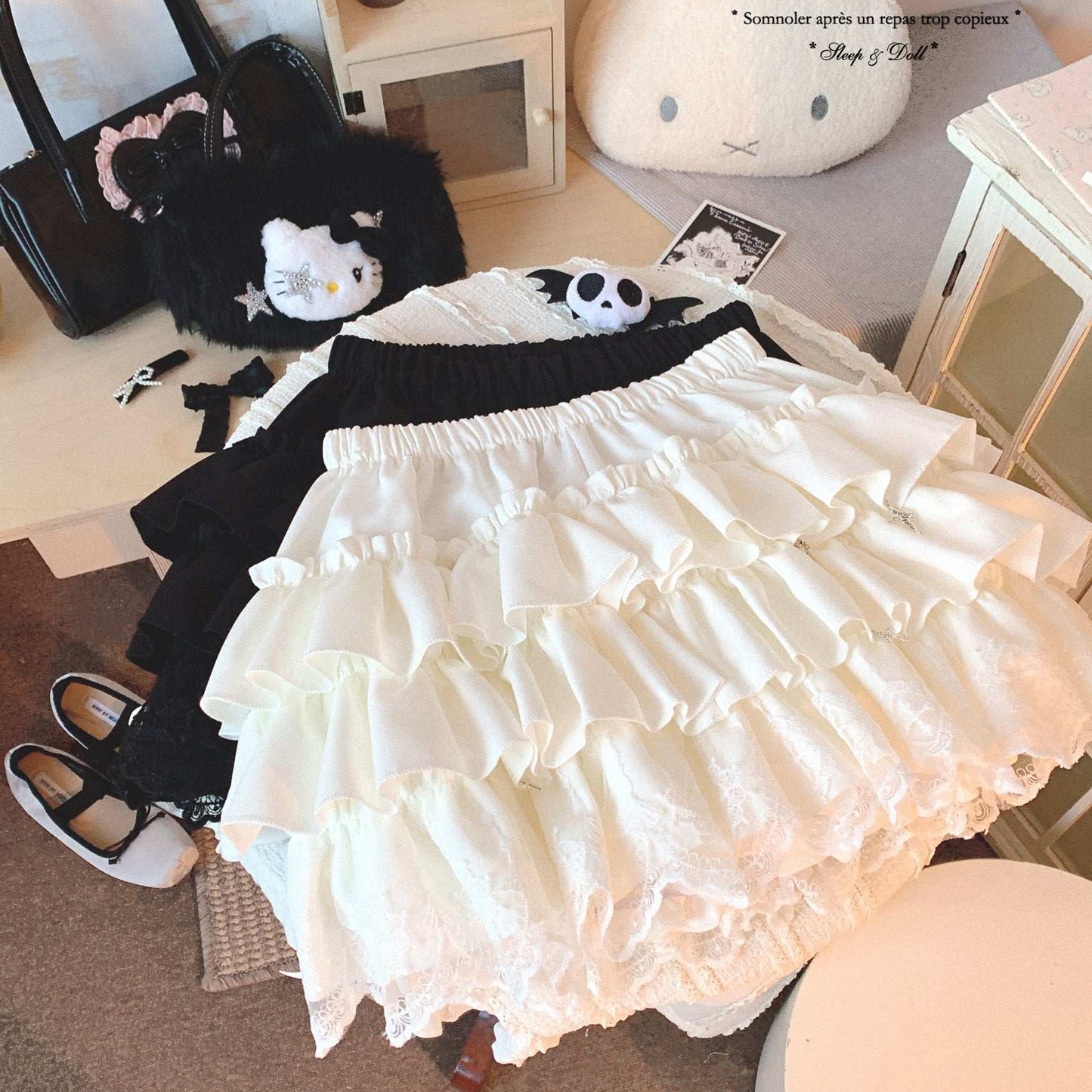 White lace skirt with black top and shoes on a bed