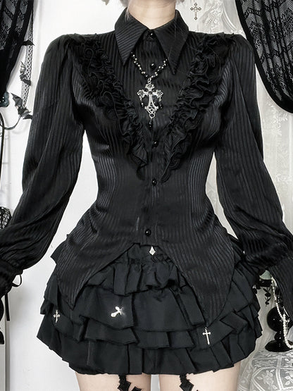 Person wearing a black gothic-style outfit with ruffles and decorative elements.