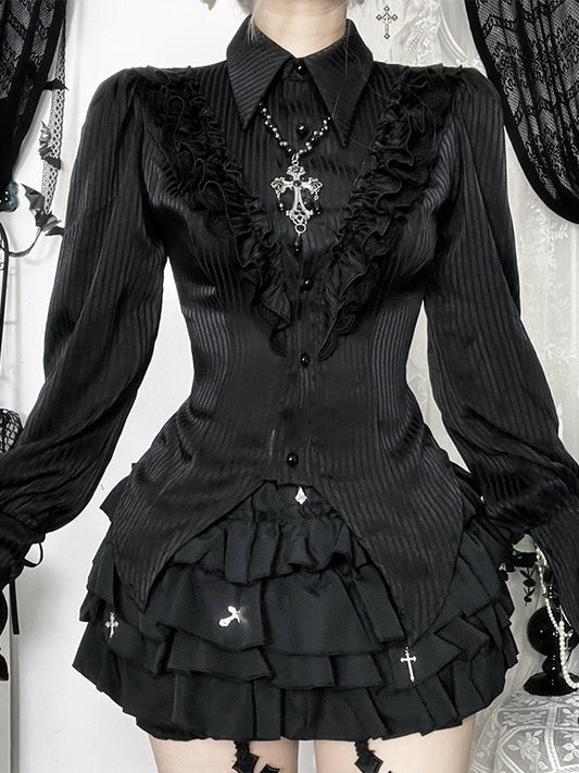 Person wearing a black gothic-style outfit with ruffles and decorative elements.