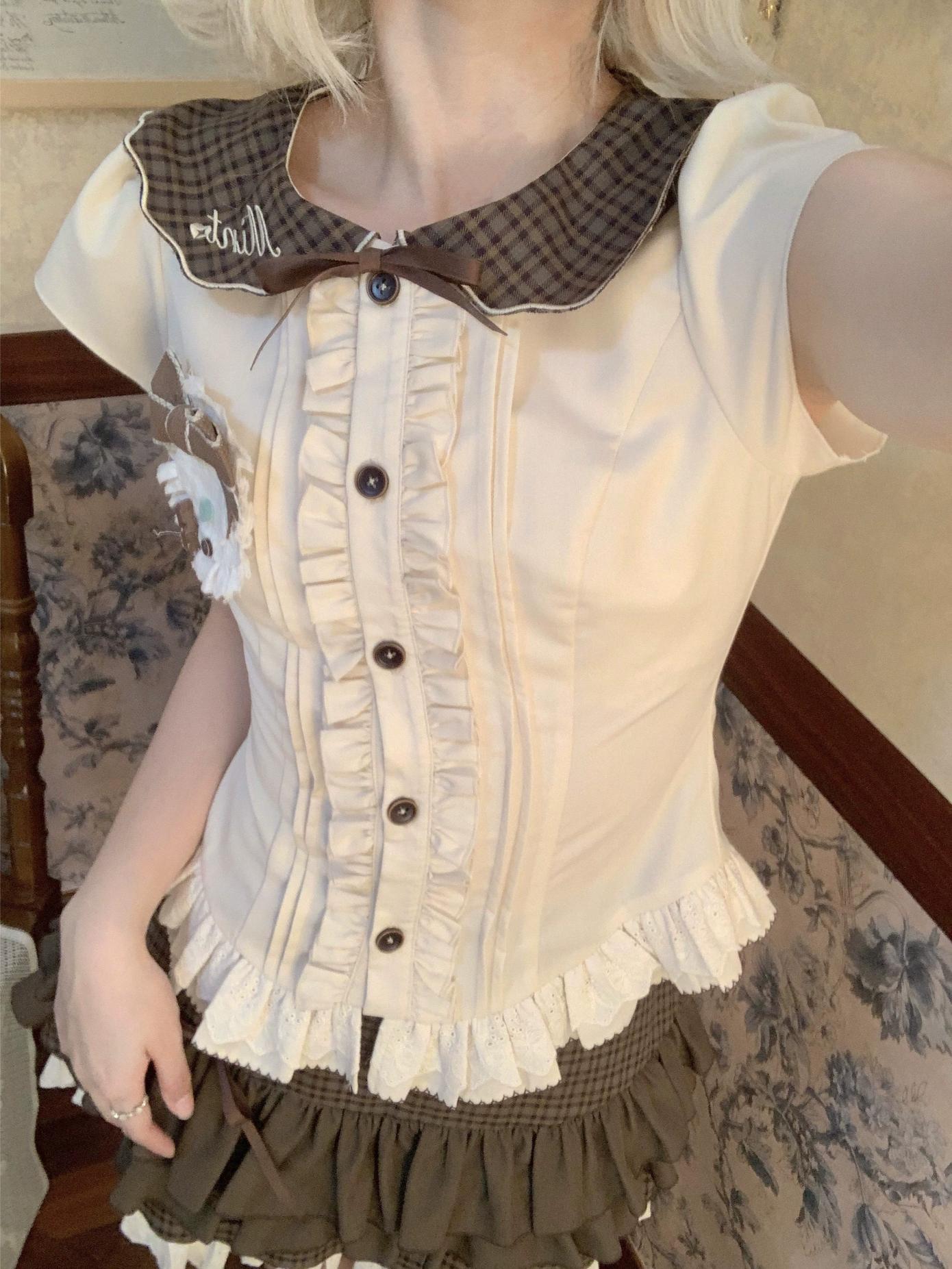 Person wearing a vintage-style outfit with a ruffled white blouse and brown checkered collar.