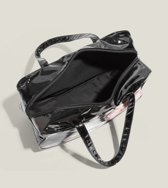 Black handbag with visible brand name on a light gray background