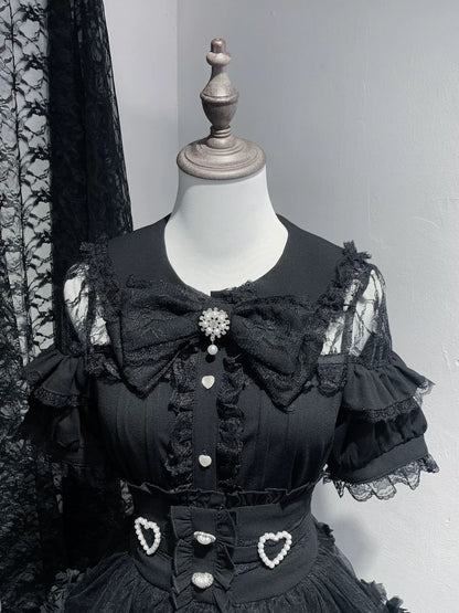 Black lace dress on a mannequin against a gray background