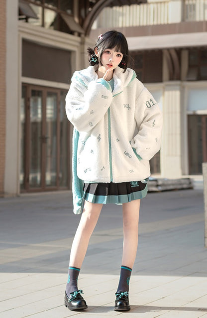 Woman wearing a white jacket with green accents and a skirt, standing outdoors.