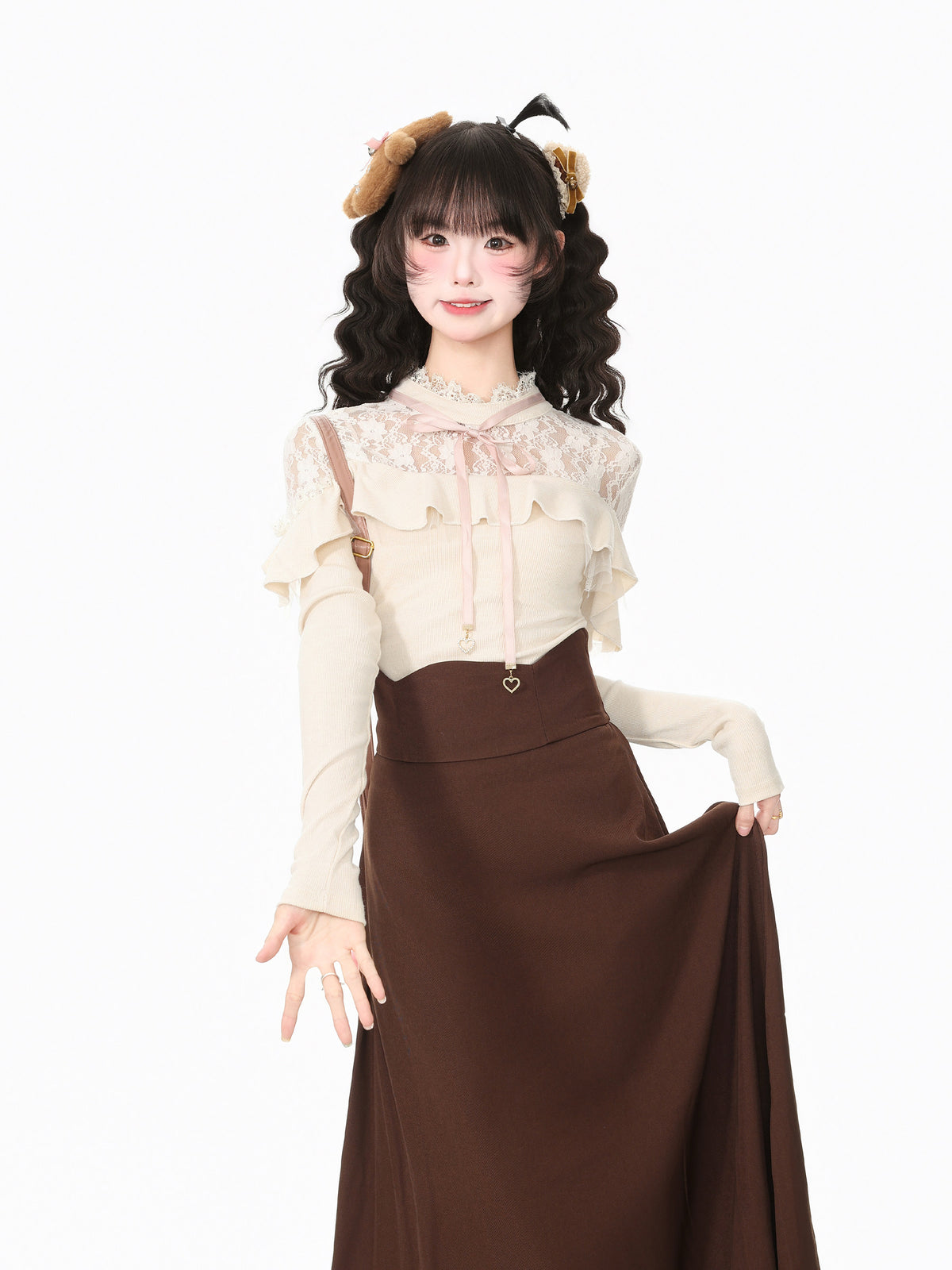 A young woman modeling a cream lace long-sleeve blouse with ruffled sleeves and a brown high-waisted midi skirt, styled with a brown headband, against a plain white background.