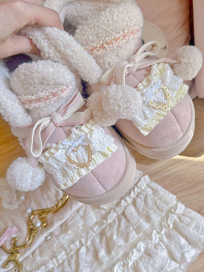 Pink shoes with decorative elements on a textured surface