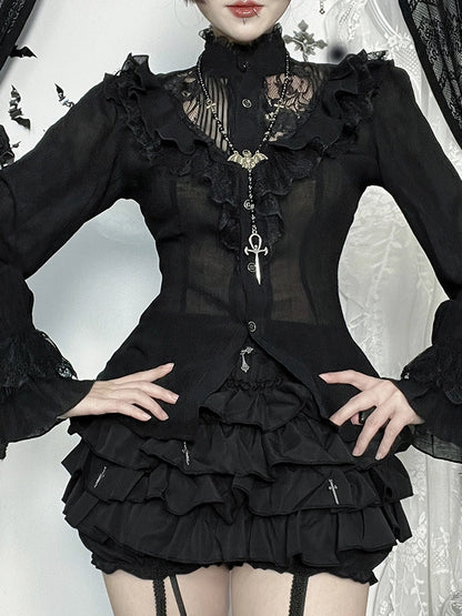 Person wearing a black gothic-style dress with ruffles and lace details.