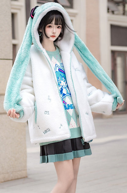 Person wearing a white coat with bunny ears and a green skirt in an urban setting