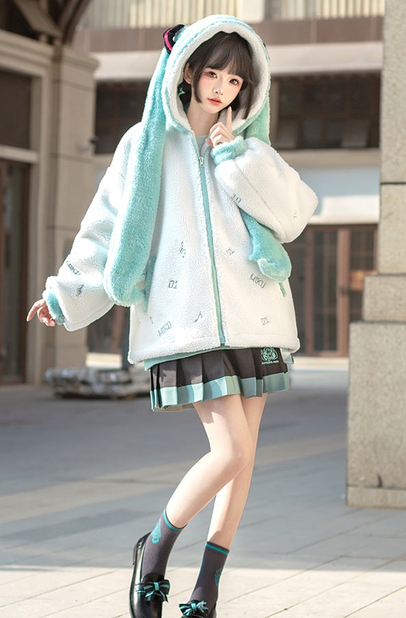 Person wearing a white and green hooded jacket with a plaid skirt on a city street.