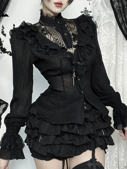 Person wearing a black gothic-style dress with ruffles and lace details.