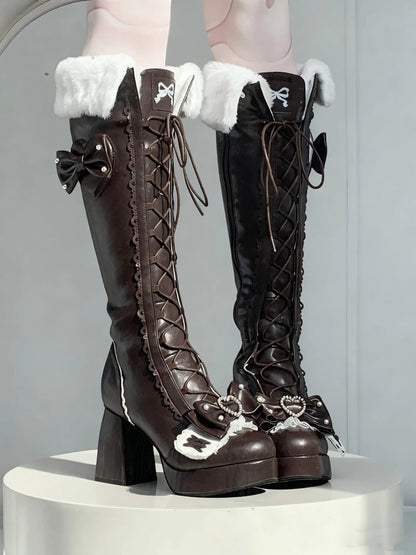 Pair of brown knee-high boots with white fur trim on a gray background