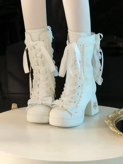 White lace-up high-heeled boots on a black background