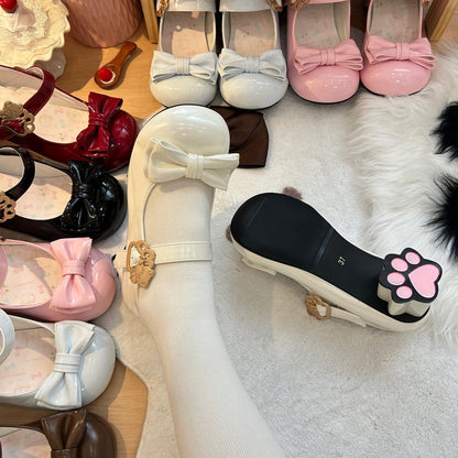 Collection of children's shoes with bows on a soft surface