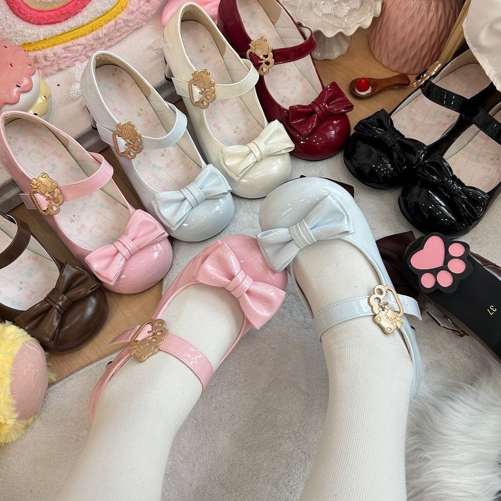 Colorful children's shoes with bows and decorative elements on a soft surface.