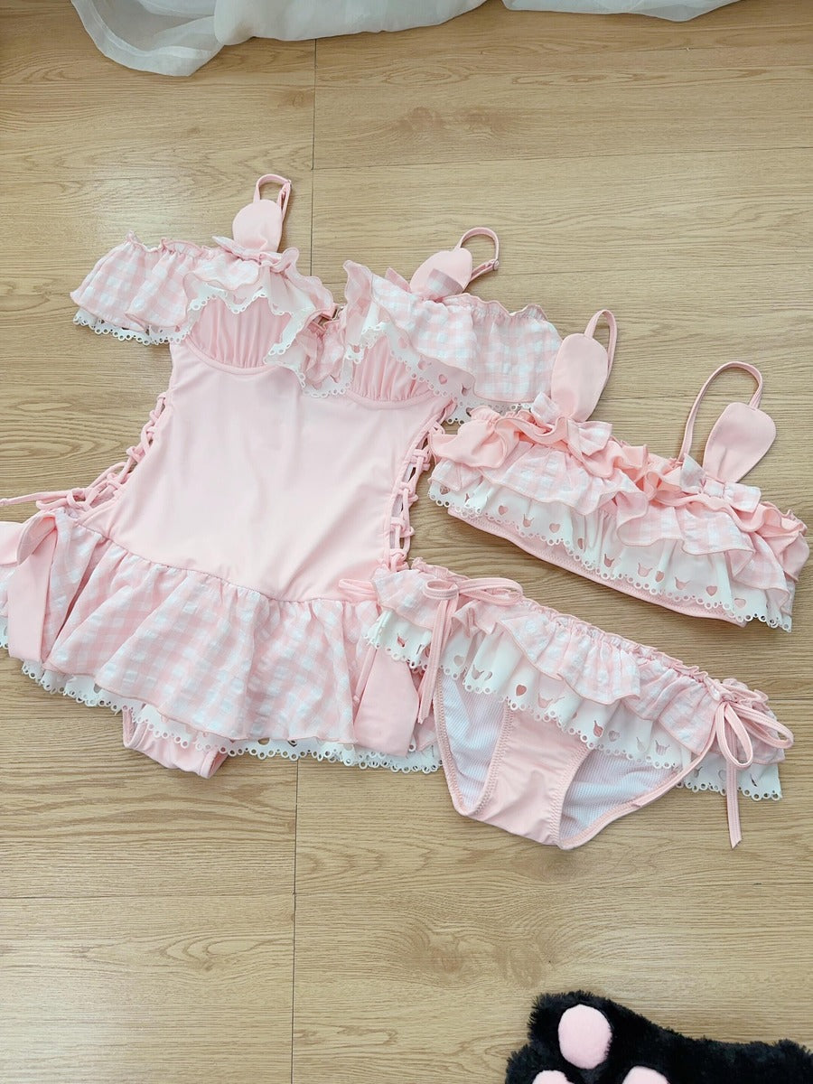 Pink swimsuit outfit with bunny ears on a wooden floor