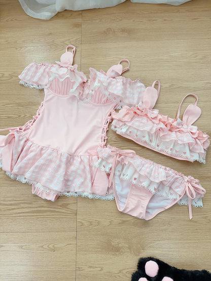 Pink swimsuit outfit with bunny ears on a wooden floor