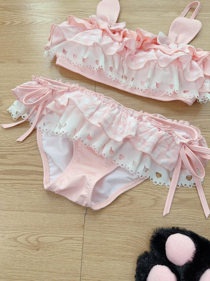 Pink lace lingerie set on a wooden surface