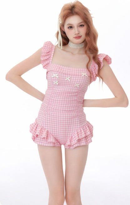 Woman wearing a pink checkered outfit with ruffled details on a white background