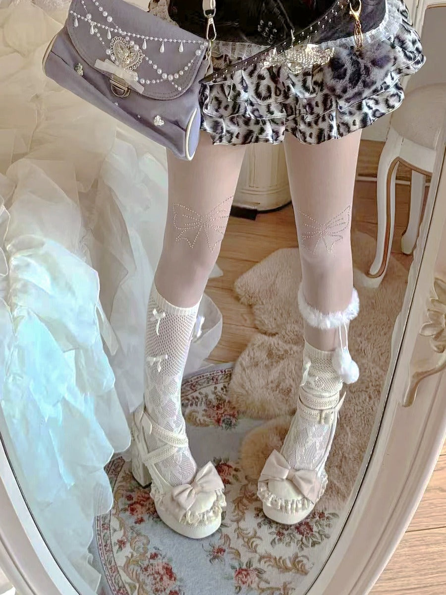 Person wearing a leopard print skirt, white fishnet stockings, and white lace-up shoes in a room.
