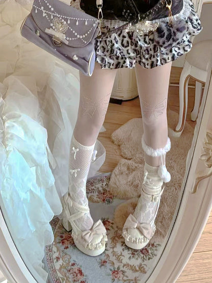 Person wearing a leopard print skirt, white fishnet stockings, and white lace-up shoes in a room.